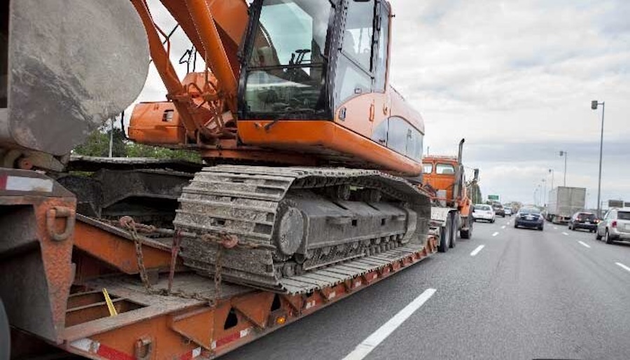 Excavator transported on lowboy trailer