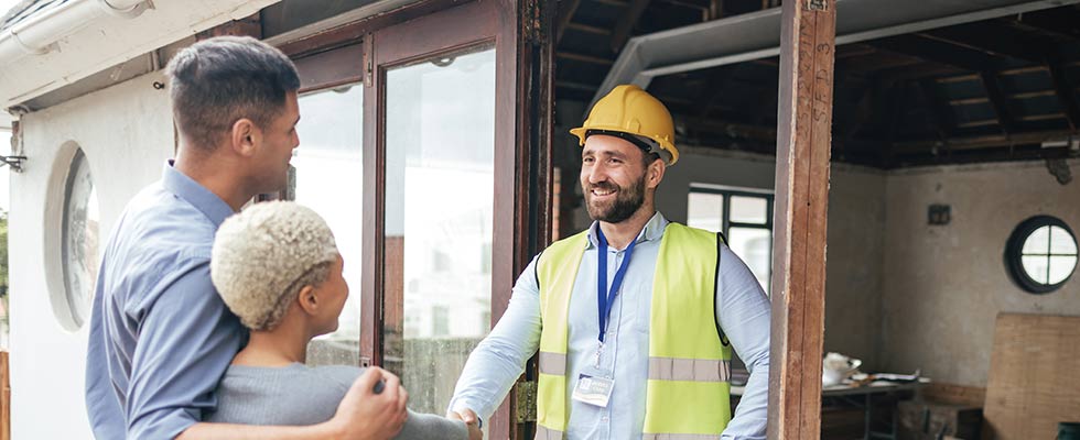 Contractor smiling at people to illustrate the value of in-person events