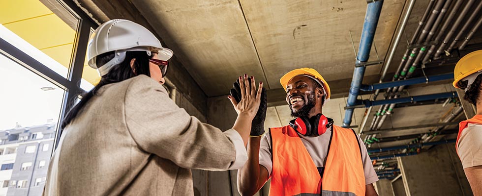 Two contractors high fiving