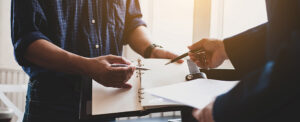 Two people gesturing at document