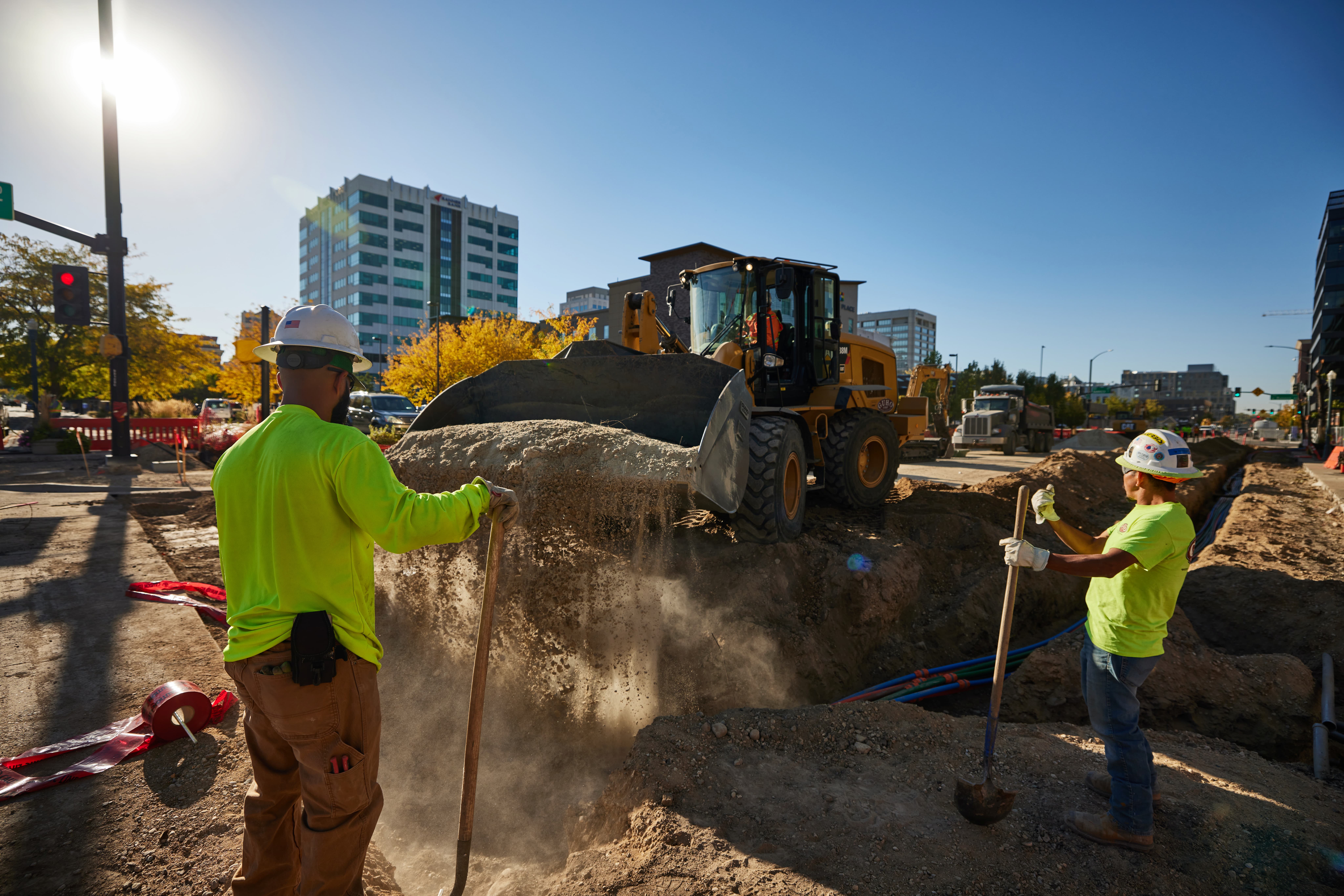 Construction workers on jobsite with Caterpillar machine 