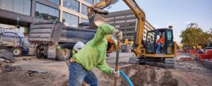 Construction worker on jobsite with Caterpillar machine