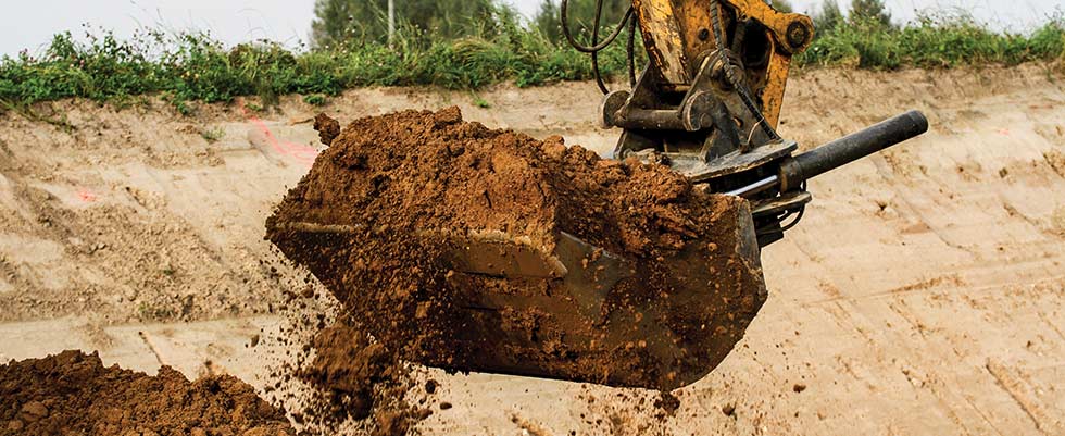 Excavator bucket full of dirt