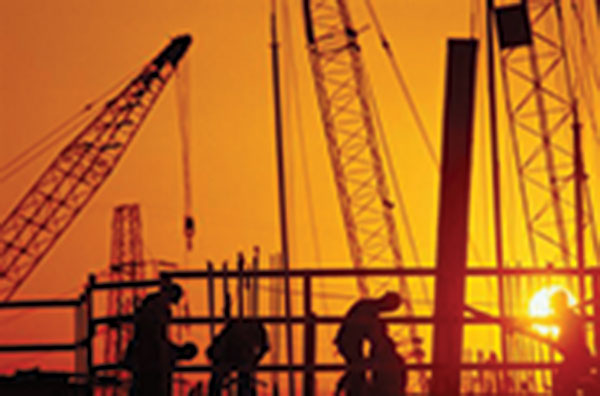 construction workers onsite at sunset