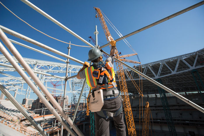 Worker installing steel framework beams
