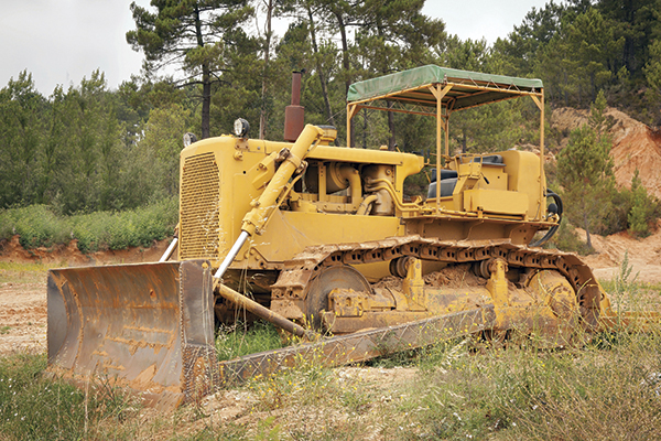 Yellow bulldozer on dirt site