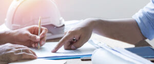two sets of hands working on a contract