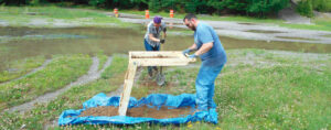 Workers conducting soil testing at construction site
