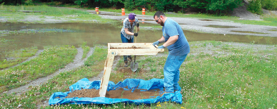 Workers conducting soil testing at construction site