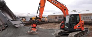 Excavator with hydraulic attachment at jobsite