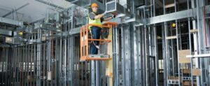 construction worker at height on a lift
