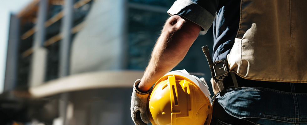 construction worker with hard hat in hand