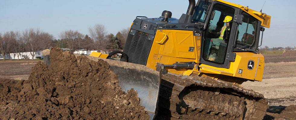 Bulldozer pushing soil at construction site