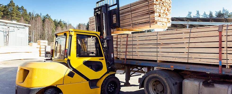 lumber being loaded for hauling