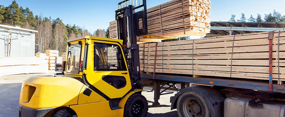 lumber being loaded for hauling
