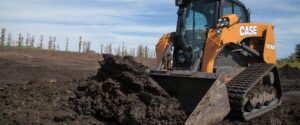 Case track loader pushing soil.