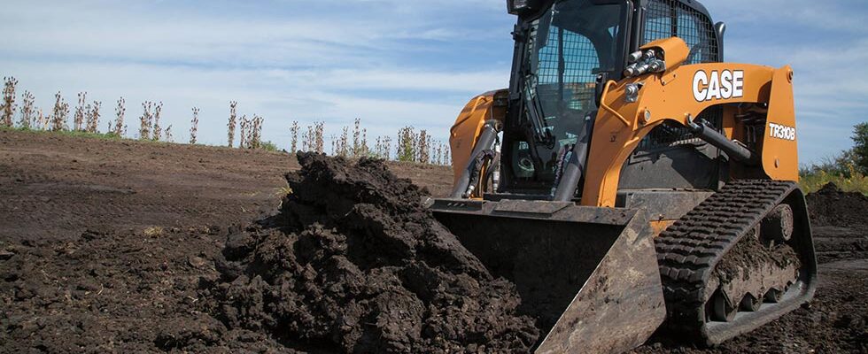 Case track loader pushing soil.