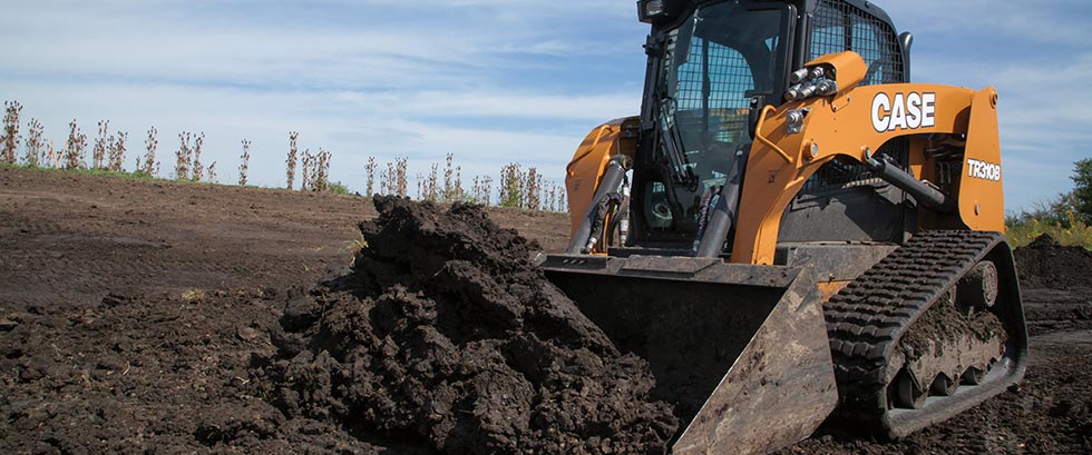 Case track loader pushing soil.