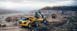 Excavator loading articulated dump truck
