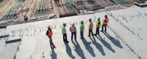 construction workers standing in line ona roof