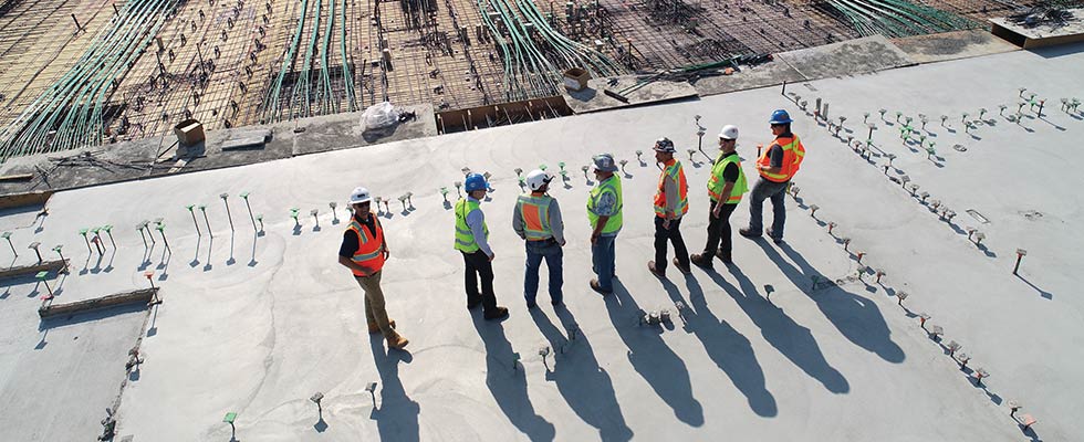 construction workers standing in line ona roof