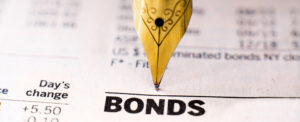quill pen writing on a bond contract