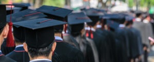 tops of graduation hats on graduates
