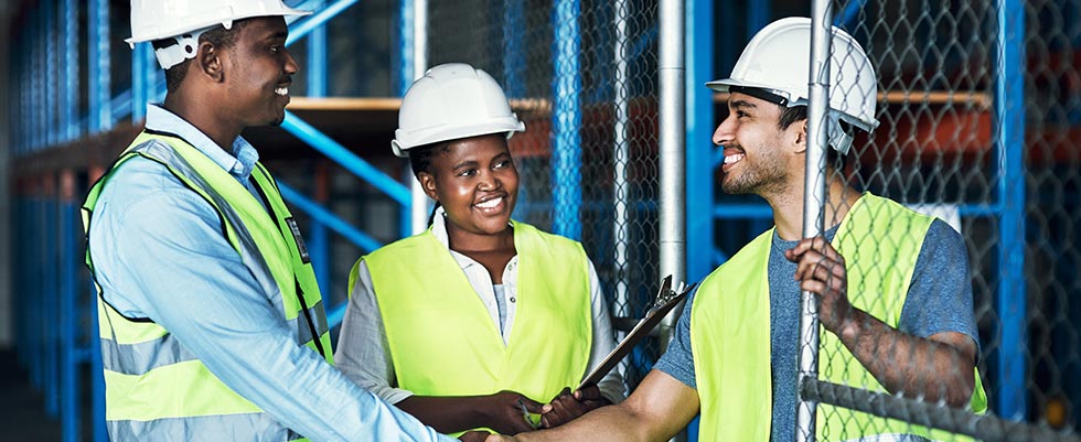 3 construction workers talking onsite
