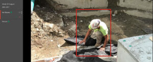 Construction worker performing excavation work under predictive analytics monitoring