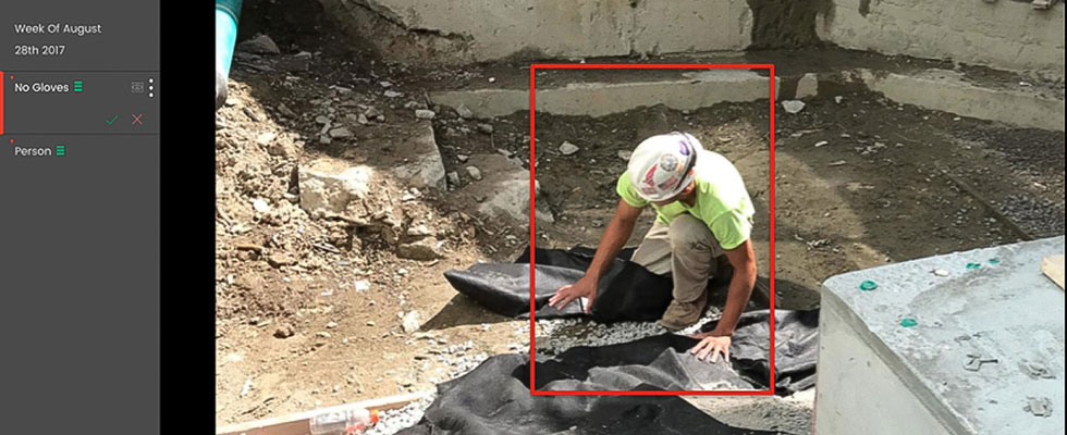 Construction worker performing excavation work under predictive analytics monitoring