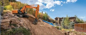 excavator doing dirt work on a slope
