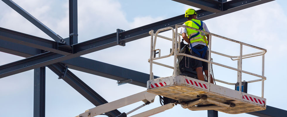 construction worker working at height with fall protection gear