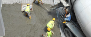 construction workers pouring concrete