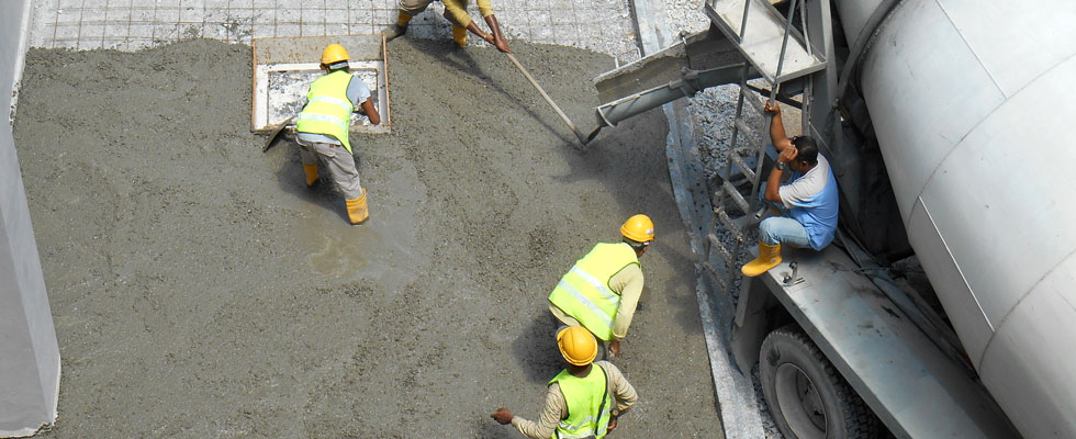 construction workers pouring concrete